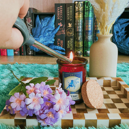 Pixie Dust Candle on a chequered board with flowers