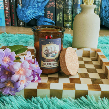 Lost in the books Candle on a chequered board with flowers