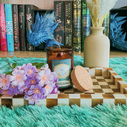 Marshmallow Dream candle on chequered board with flowers