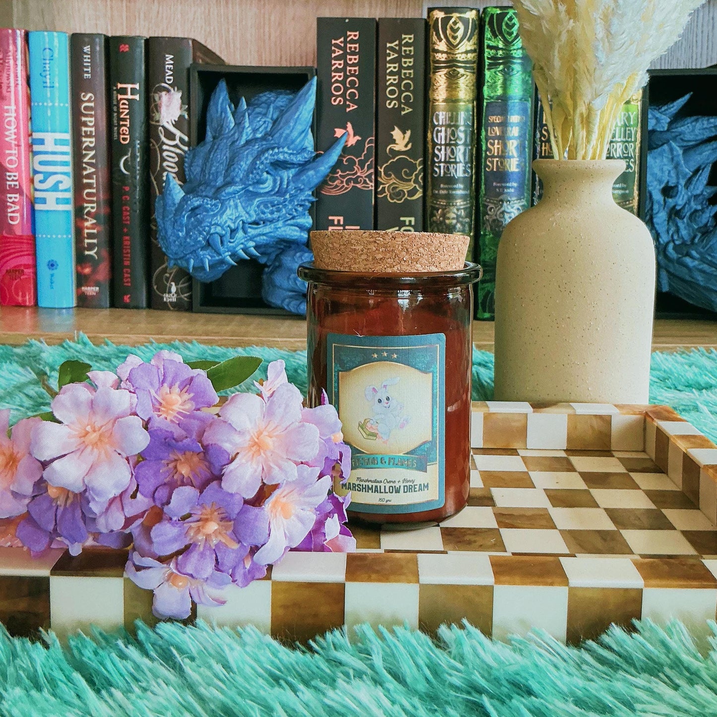 Marshmallow Dream candle on chequered board with flowers