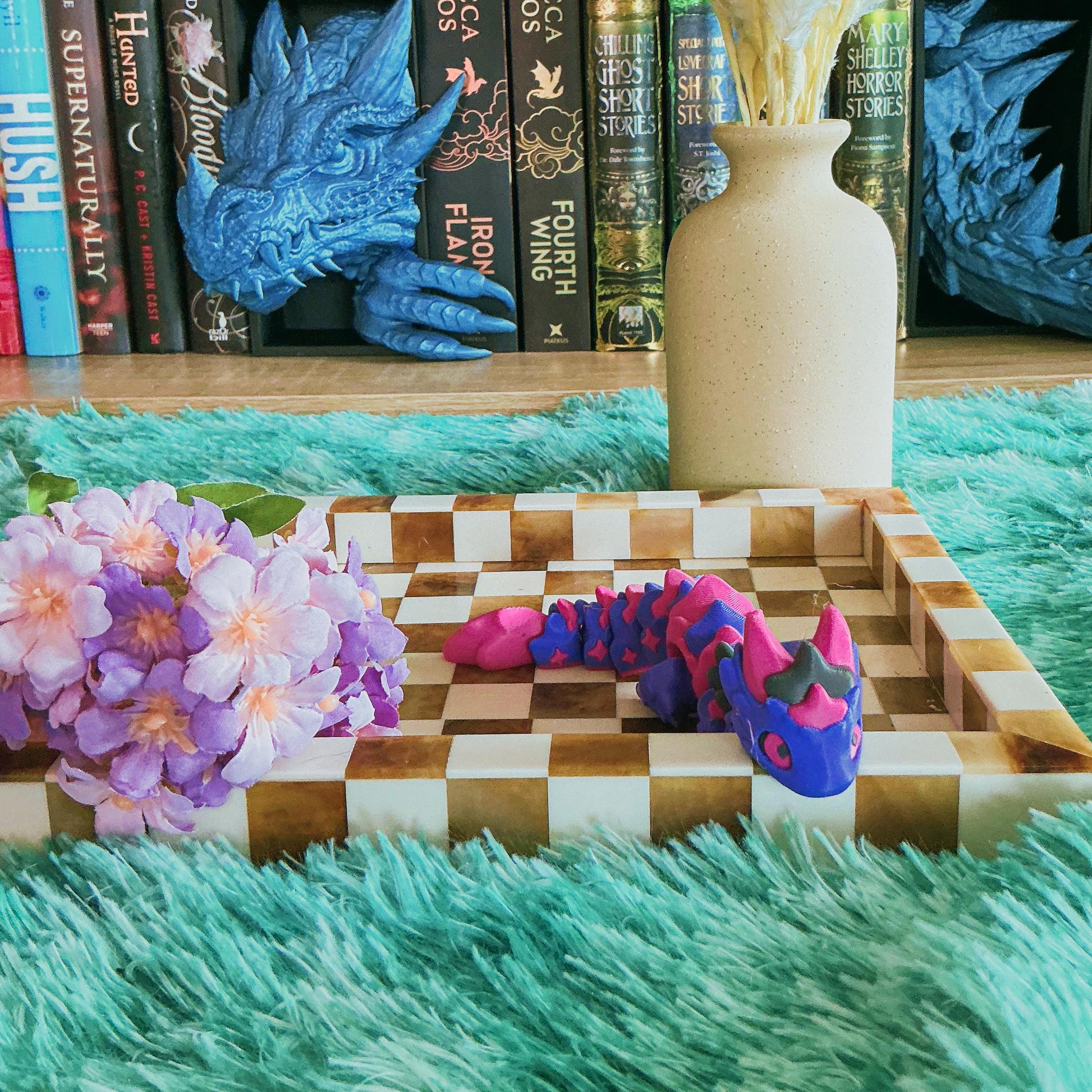 magenta and purple dragon on chequered board with flowers