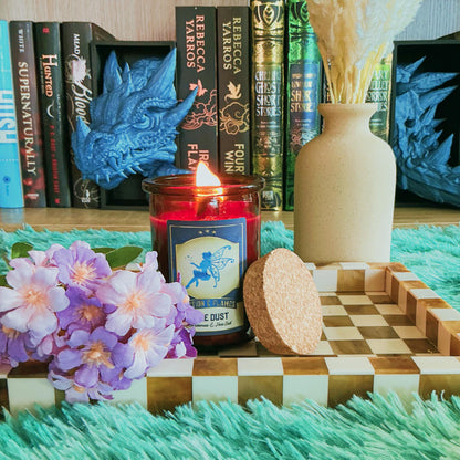 Pixie Dust Candle on a chequered board with flowers