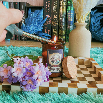 Lost in the books Candle on a chequered board with flowers