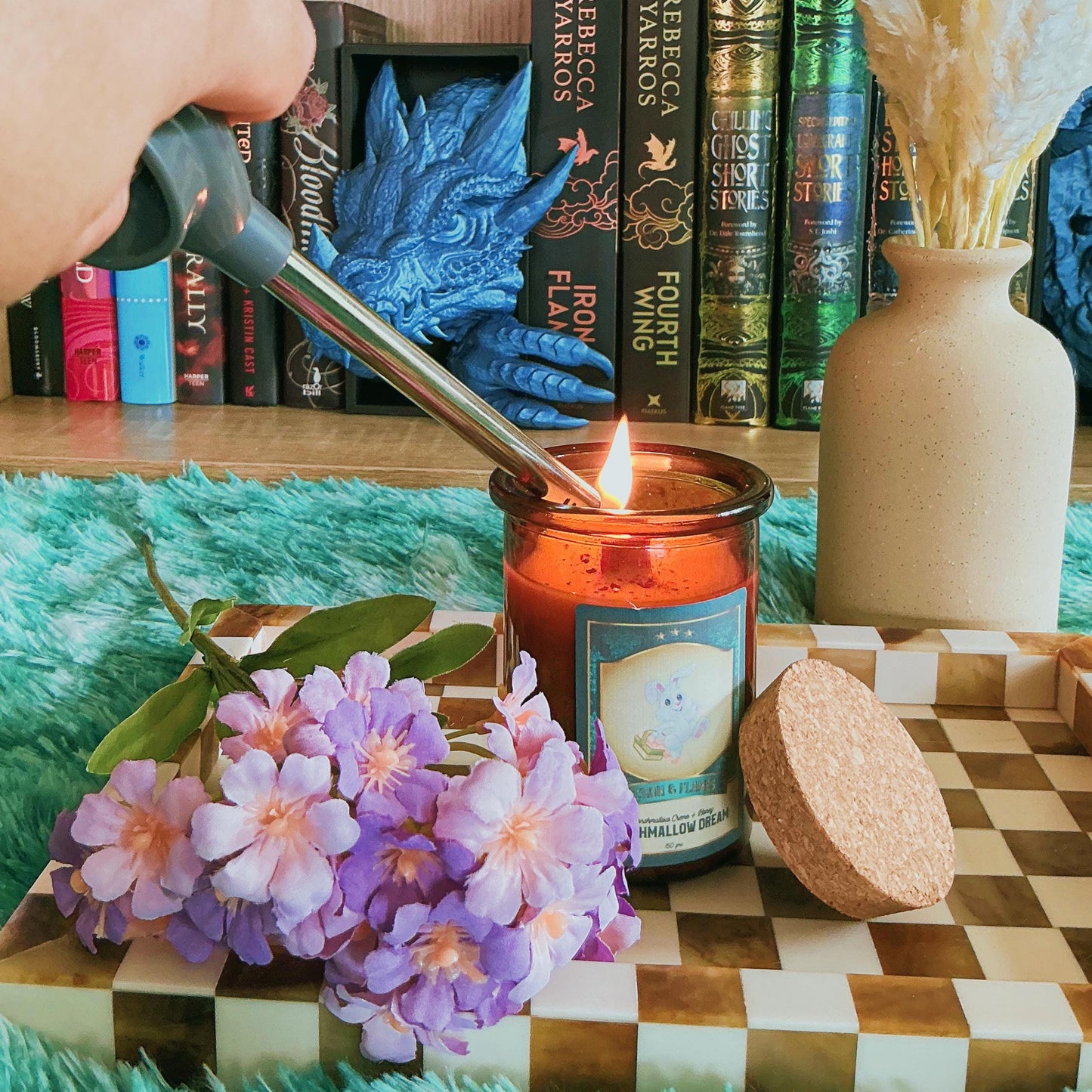 Marshmallow Dream candle on chequered board with flowers