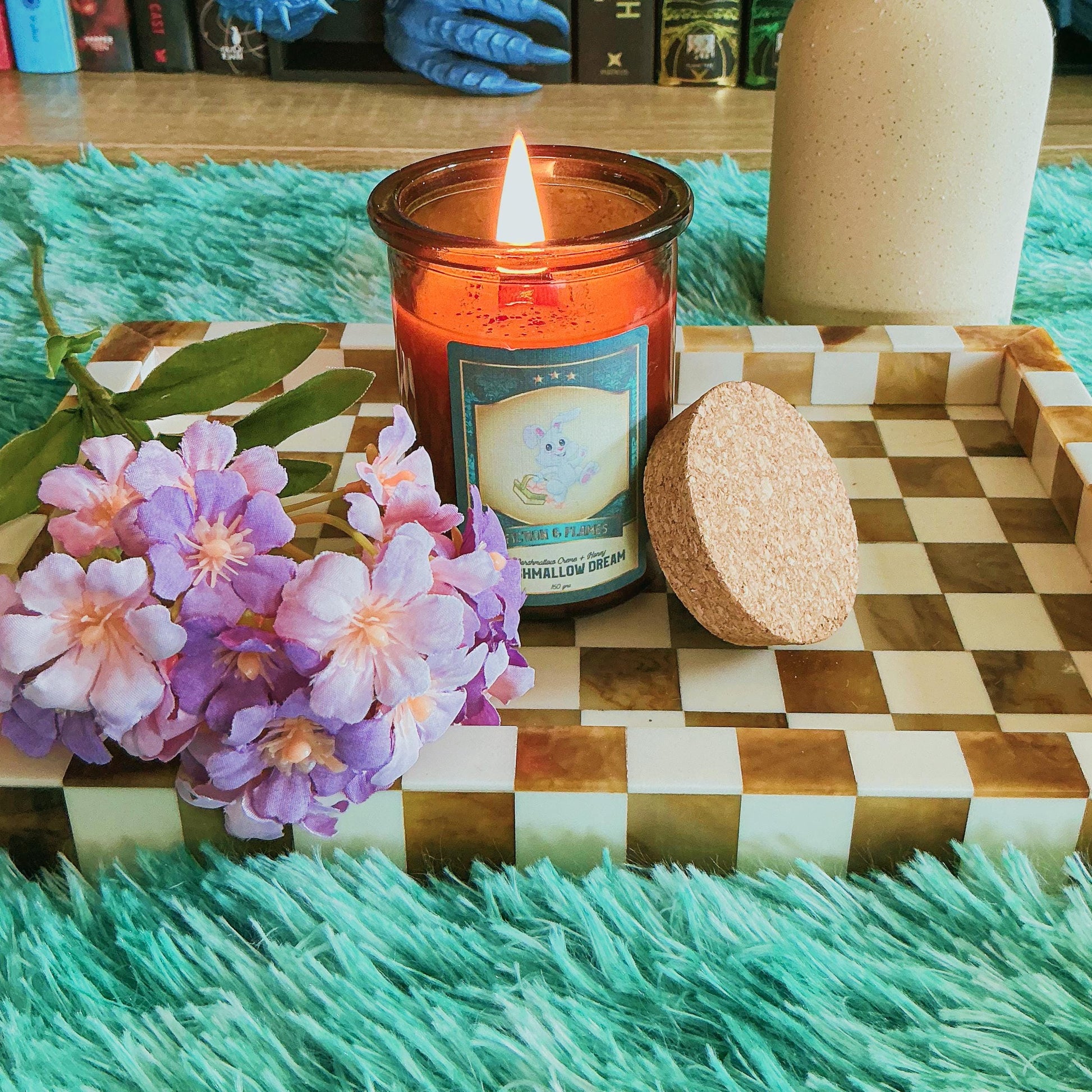 Marshmallow Dream candle on chequered board with flowers