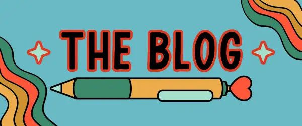 A stylized pencil with a green body, orange grip section, and light blue eraser, featuring a red heart-shaped tip.